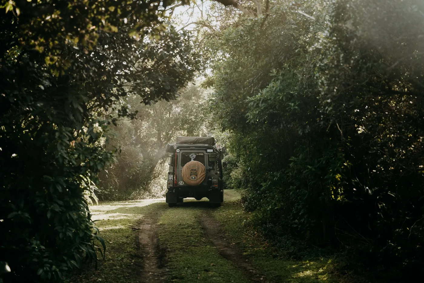 Restored Land Rover Defender being road-tested on a forest track
